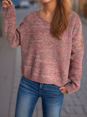 Textured slouch v-neck sweater in dusty pink with multi-color flecks, acrylic knit.