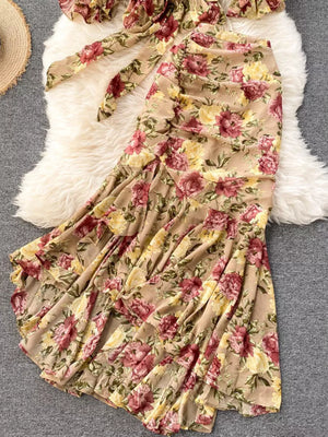 Chic floral two-piece crop set with a bow detail and ruffled skirt in tan with pink and yellow flowers.