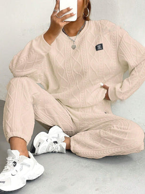 Tan cable knit loungewear set with crew neck sweater and relaxed fit pants.