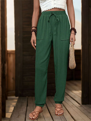 Dark green textured drawstring waist relaxed trousers with pockets