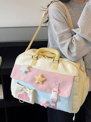 Chic color block travel bag with star embellishments and pastel pink, blue, and yellow panels.