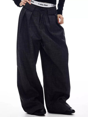 Men's dark grey wide-leg trousers with pleats and a textured fabric.