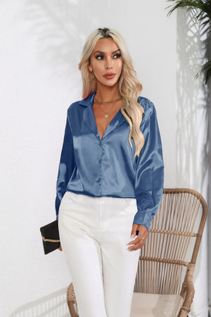 Glossy satin button-down blouse in light blue with a V-neck and long sleeves.