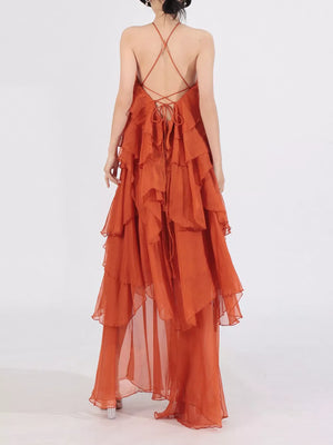 Orange halter maxi dress with cascading ruffles and crisscross back ties.