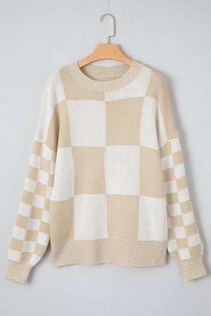 Beige and white checkerboard knit sweater with crewneck and ribbed cuffs and hem.