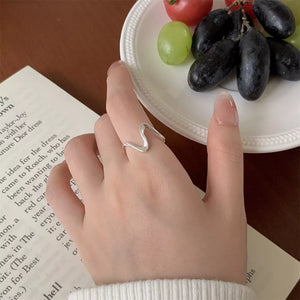 Wavy minimalist sterling silver ring with a modern, sleek design.