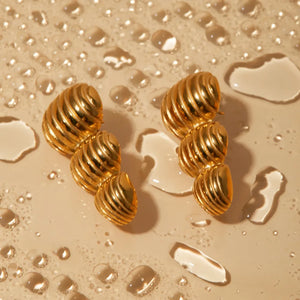 Gold drop earrings with a sculptural spiral design, 18K gold-plated.