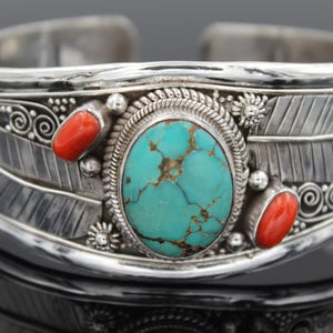 Turquoise and coral cuff bracelet with feather details in sterling silver.