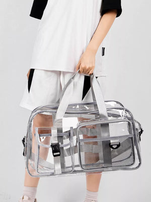 Clear transparent duffel bag with grey trim and multiple exterior pockets.
