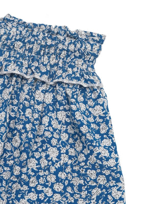 Light blue mini skirt with ditsy floral print and ruffled smocked waist.