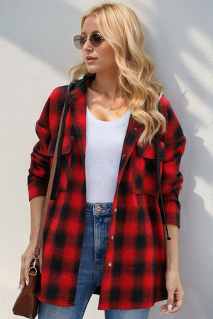 Oversized red and black plaid hooded shirt jacket with buttoned front and chest pockets.
