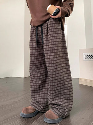 Men's brown plaid wide leg trousers with drawstring waist.