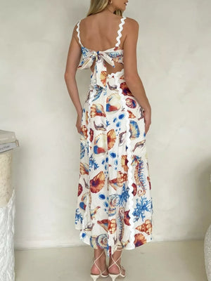 Midi dress with seashell print, scalloped trim, and tie-back detail.