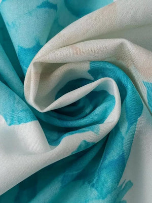 Teal floral print maxi dress fabric detail with V-neck and ruffle sleeve style
