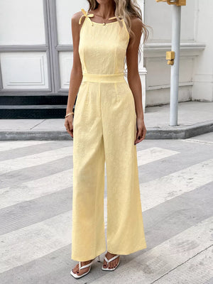 Yellow tie strap wide-leg jumpsuit with subtle floral texture and defined waist