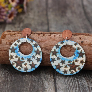 Multicolor celestial starburst wood hoop earrings with a boho pattern.