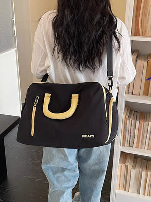 Black travel organizer bag with yellow accents and adjustable strap
