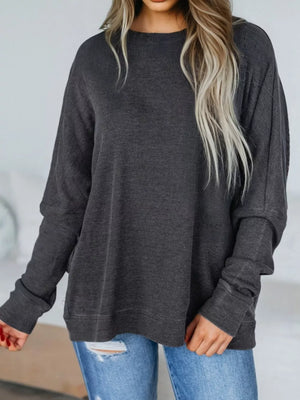 Dark gray waffle knit oversized sweatshirt with crew neck and long sleeves.