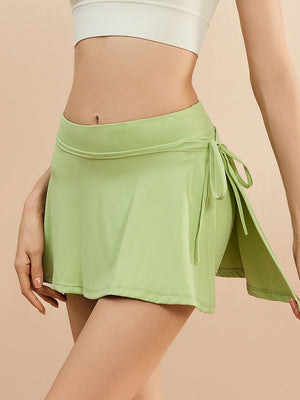 Lime wrap-detail skort with side tie and a flattering A-line cut.