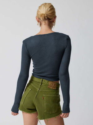 Navy ribbed crop top with long sleeves and a scoop neck, shown from the back.