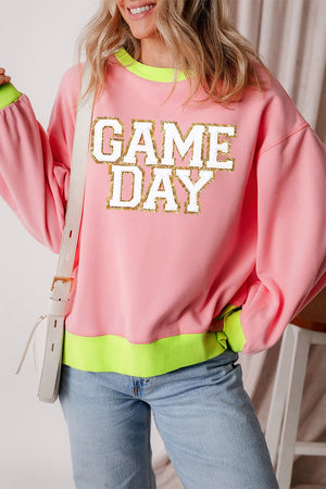 Pink sweatshirt with "GAME DAY" appliqué and neon trim