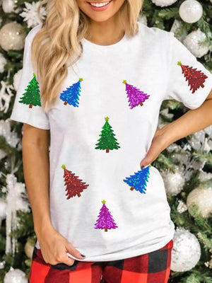 White t-shirt with scattered sequin Christmas trees in red, blue, green, and purple.