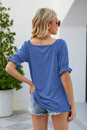 Cobalt blue gathered square neck puff sleeve top with ruffled cuffs.