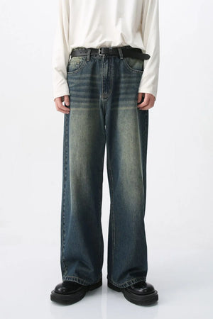 Faded wash wide-leg denim jeans in medium blue with a relaxed fit.