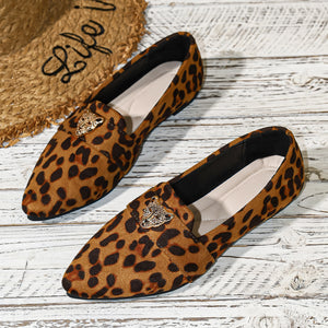 Point toe slip-on flats with leopard print and gold leopard head detail.