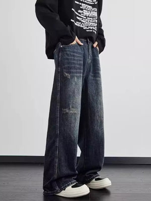 Distressed wide leg men's dark wash denim jeans with a relaxed fit.
