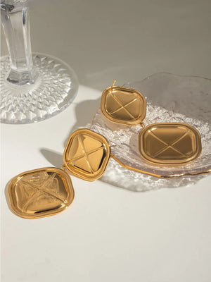 Sculpted geo drop earrings in gold-plated metal with a unique geometric design.