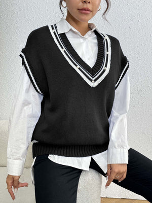 Black acrylic knit vest with v-neck, varsity stripes and pearl trim detail.