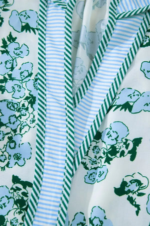 Floral print polyester blouse with ruffled trim and striped details