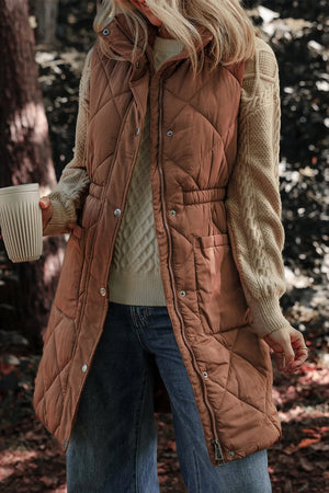Brown diamond quilted longline vest with cinched waist detail and snap front.