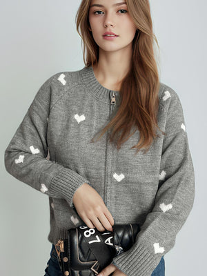 Gray zip-through knit cardigan with white heart pattern, crew neck, long sleeves.