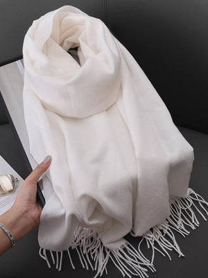 White fringe scarf with a soft texture, perfect for versatile styling.