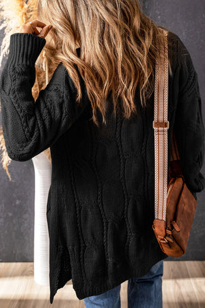 Black cable knit open-front cardigan with textured pattern and side slits.