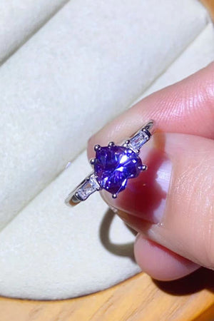 Purple heart-cut moissanite ring with baguette accents in platinum.