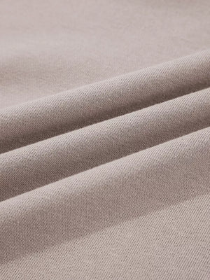 Multi-tonal relaxed fit cotton hoodie in a soft taupe color, showing fabric texture.