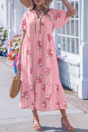 Pink floral midi dress with flutter sleeves and tiered skirt.