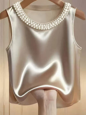 Pearl embellished satin tank top in apricot with round neckline.
