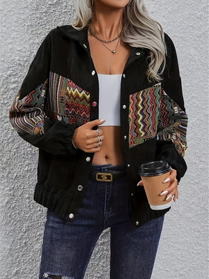Black corduroy bomber jacket with colorful embroidered patchwork details on sleeves and chest.