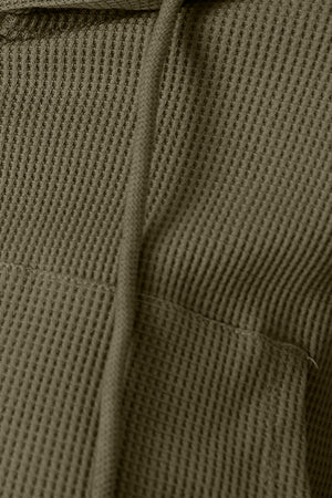 Army green waffle knit cropped zip hoodie with drawstring and pocket detail.