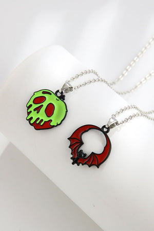 Spooky season enamel pendant necklaces, one green skull, one red bat.