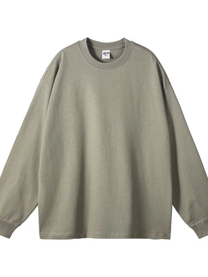 Oversized drop-shoulder crewneck pullover in sage green 100% cotton with long sleeves.