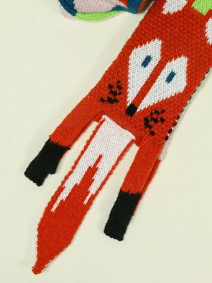 Chunky knit scarf with a red fox design, white face, blue eyes, and black accents.