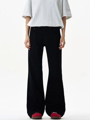 Black wide-leg sweatpants with a relaxed fit and flared hem, styled with a grey t-shirt.