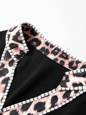 Black blouse with leopard print trim and striped piping detail.