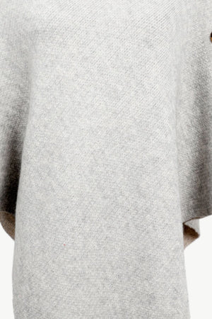 Light gray acrylic knit poncho with button detail and turtleneck