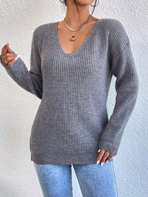 Gray ribbed knit sweater with V-neck and long sleeves, featuring a subtle lace detail on the back.